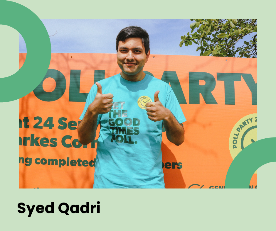 Western Bay Council Staff member Syed Qadri posing in front of an orange sign signaling a thumbs up